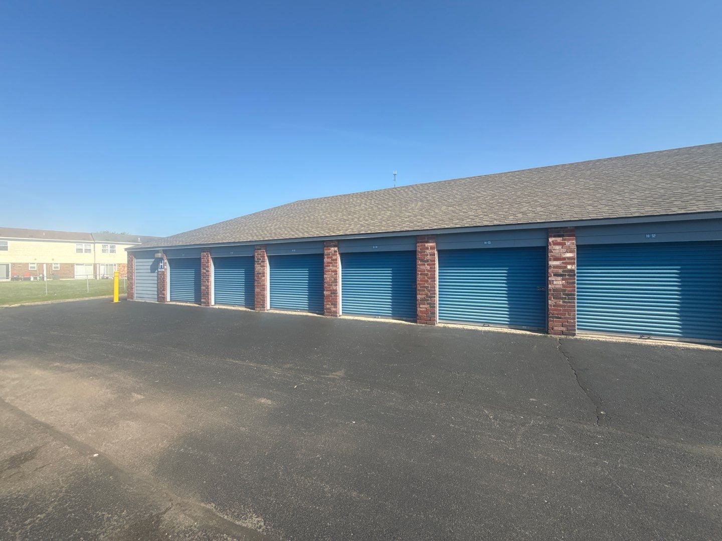 Completed commercial storage facility — new architectural shingle roofs across multiple buildings